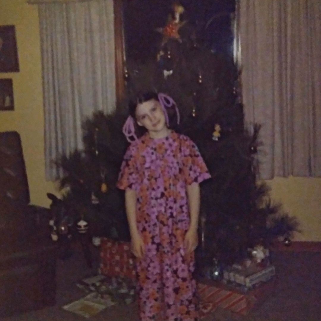 Christy Hoss in front of Christmas tree